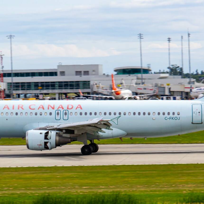 white and red passenger plane on airport during daytime